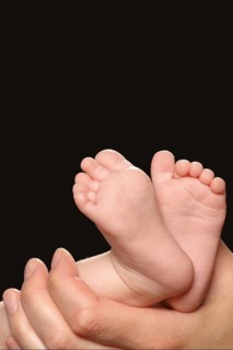 A hand holds the feet of a baby, Baby, Newborn, Child, Nude Hamburg, Federal Republic of Germany