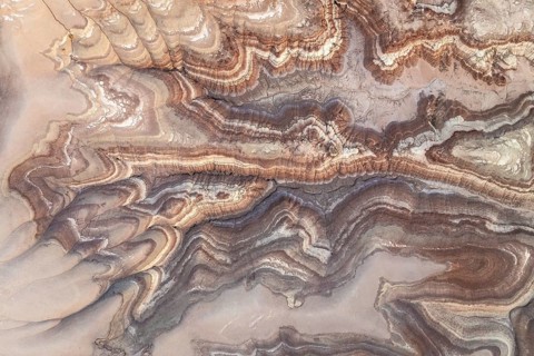 Aerial shot capturing the intricate patterns of bentonite sandstone in Utah, USA. The natural