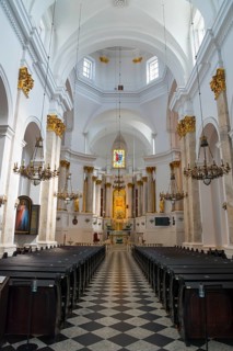 Elegant baroque church interior with arches and ornate chandeliers, Basilica of the Nativity of the