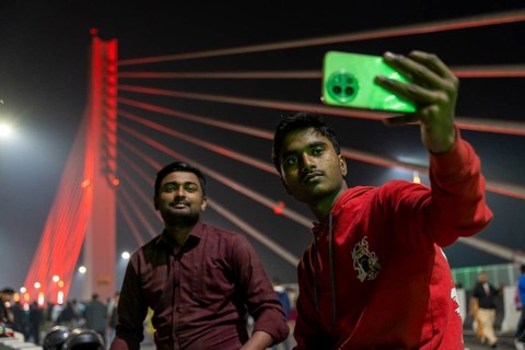Young men take selfies on the newly inaugurated Kumar Bhaskar Varma Setu, a six-lane cable-stayed