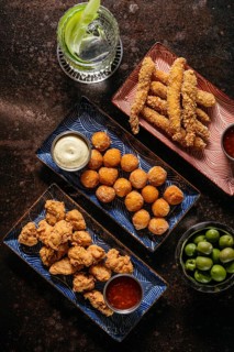 A delectable fried chicken and shrimp platter featuring golden-brown crispy breading, accompanied