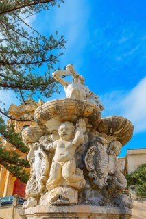 View of Hercules fountain and San Domenico church in the background, Noto Valley, Sicily, Italy