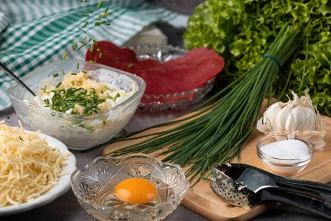 Ingredients such as fresh garlic, chives and sour cream prepared for a hearty dish
