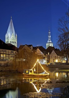 Large pond, St. Patrokli Cathedral and St. Peter's Church in the evening during winter sunshine,