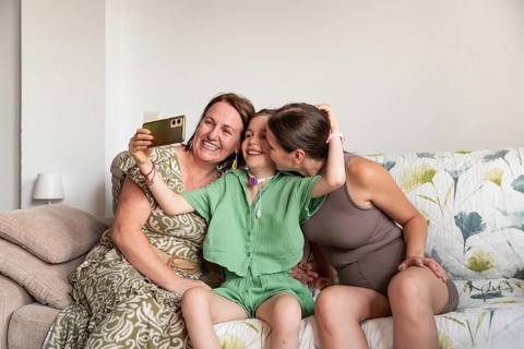 A heartwarming scene of a family with a disabled girl with a tracheostomy, sharing a joyful moment.
