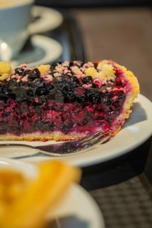 Close-up of a berry cake with creamy filling, served on a plate, autumn creations, Cafe Kuh,