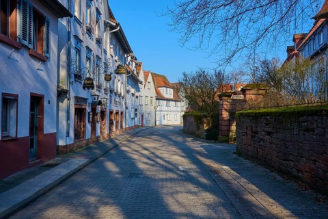 Picturesque alley with half-timbered houses under a clear blue sky in a quiet area, Am
