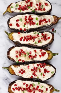 Fried eggplant with sauce, decorated with microgreens and pomegranate seeds, eggplant appetizer,
