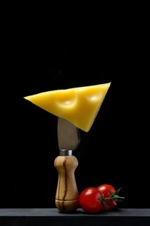 A piece of Swiss Emmental cheese on a cheese knife
