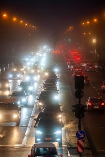 Dense fog, with visibility sometimes less than 100 metres, city centre traffic at rush hour on