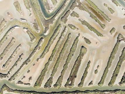 Saline ponds at the salt works near Chiclana de la Frontera. Aerial view. Drone shot. Bahía de