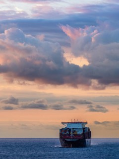 Maersk Line Container Ship on sea at sunrise, Barcelona, Spain