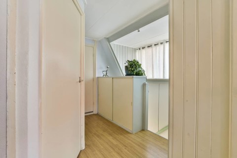 A clean, spacious interior showcasing a minimalist design with natural lighting and light-colored