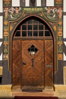 Historic wooden door with carvings on the half-timbered house Lange Bank from 1889 in the Old Town,