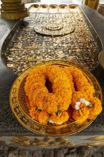 Flower garlands as an offering at Buddha's footprint, Wat Chana Songkhram, Bangkok, Thailand