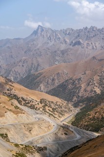 Winding roads on the Pamir Highway, mountain road through an eroded mountain landscape, Kyrgyzstan