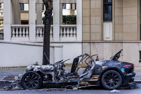 Burnt out Jaguar car on the side of the road, Mitte, Berlin, Germany