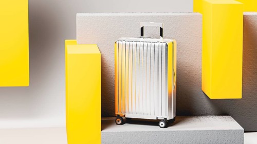 Vivid colored suitcase stands prominently on a minimalist display, highlighting sleek design and