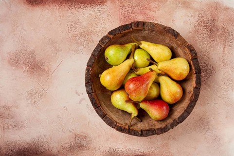 Pears, Duchess variety, small pears, early harvest, in a wooden plate, top view, no people