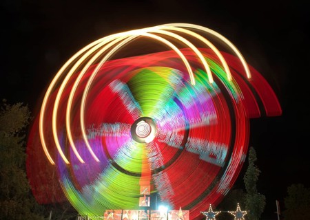 A dazzling long exposure photograph capturing the swirling motion of colorful lights on an