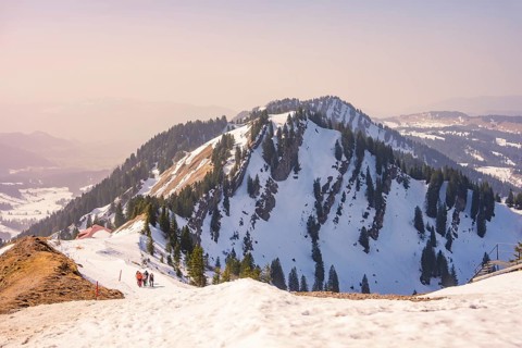 Hikers climb snow-capped mountain with breathtaking views, Hochgrat Mountains, Allgäu Alps,