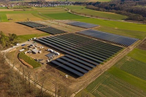 Large solar fields surrounded by green and brown agricultural land from an aerial perspective, Agri