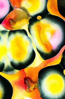 An abstract composition featuring vibrant hues of yellow, orange, and black. The textured ripples