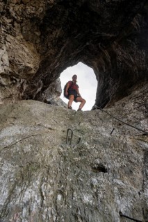 Hiker climbing through the Schindertor, Schinder, Tegernsee mountains in the Mangfall mountains,