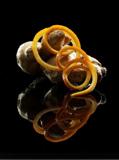 Orange peel, ginger tuber, fruit and vegetable decoration on black background, studio shot