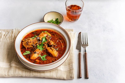 A savory bowl of Georgian chakhokhbili, a chicken stew cooked in a rich tomato sauce, infused with