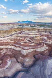 Stunning aerial shot captures the rich, multi-colored bentonite landscapes of Utah, showcasing the