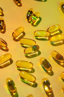 A vibrant image of translucent softgel capsules scattered across a colorful surface, symbolizing