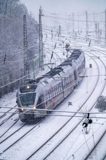Winter weather, heavy snowfall, railway tracks in front of Essen central station, local train,