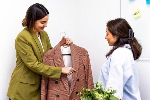Image consultants discuss a stylish blazer, highlighting personal branding and fashion advice.