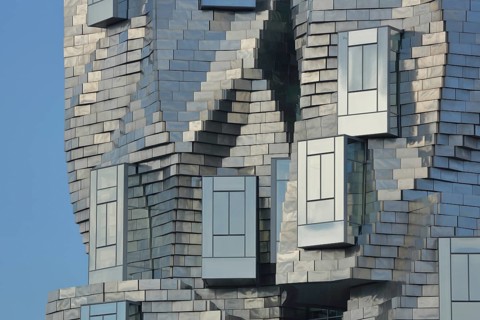 Roof with window of the modern building Tour Luma 56m high by architect Frank Gehry 2021, silver