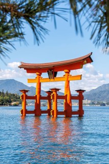 Famous red wooden torii gate UNESCO World Heritage Site on the island of Miyajima, Japan