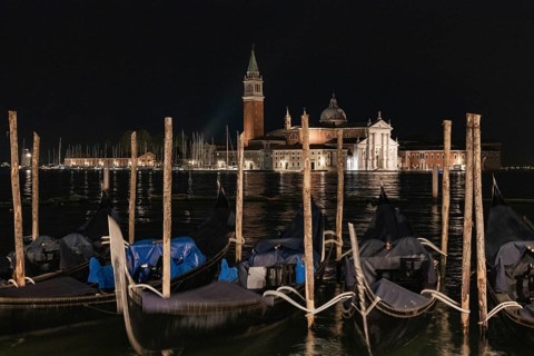 Nighttime view of San Giorgio Maggiore in Venice, Italy, showcasing the beauty of its historical