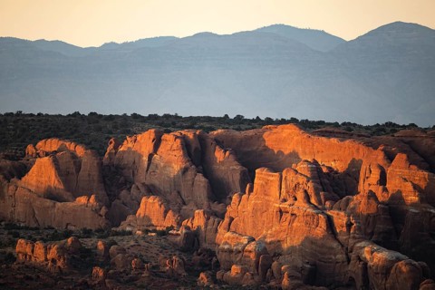 Stunning sunrise view over sandstone formations in Arches National Park, showcasing the unique