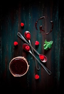 Raspberry jam, on a dark wooden background, top view, selective focus, food concept, no people