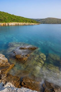 Crystal clear and turquoise water on the beach of Ustrine Bay on a sunny day on the island of Cres,