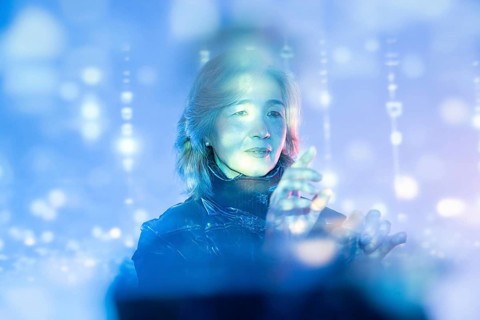 An elderly Asian woman is engaged in a dynamic scene within the metaverse, illustrating