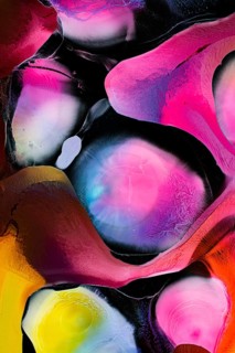 This vibrant abstract image features dynamic swirls of pink, yellow, and blue hues, creating a