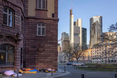 Several homeless people sleep in the morning near St. Paul's Church at the foot of Frankfurt's