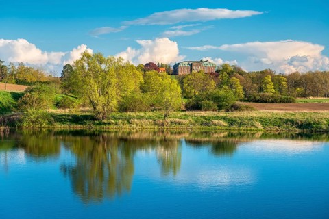 View of a small lake at Burgscheidungen Castle in evening light in spring, Unstrut Valley,