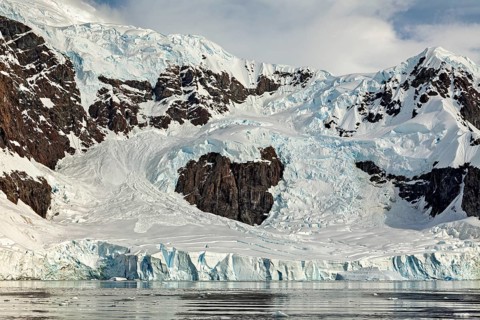 Detailed view of rock formations and glaciers with strong contrasts that convey a harsh and cold