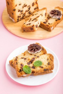 Homemade cake with raisins and dried persimmon on a pink pastel background. Side view, close up,