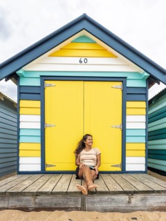 A cheerful scene of the iconic Brighton Bathing Boxes in Melbourne, Australia, showcasing vibrant