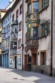 Historic town houses with artfully decorated bay windows and traditional guild signs, signs in