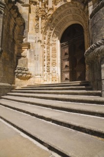 Steps and arched entrance door decorated with architectural details at the Convent of Christ in