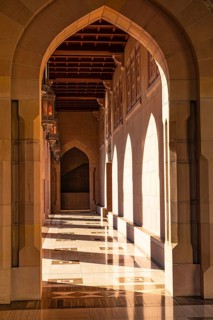 Sunlit arcade of the Sultan Qaboos Mosque, Muscat, Arabian Peninsula, Sultanate of Oman
